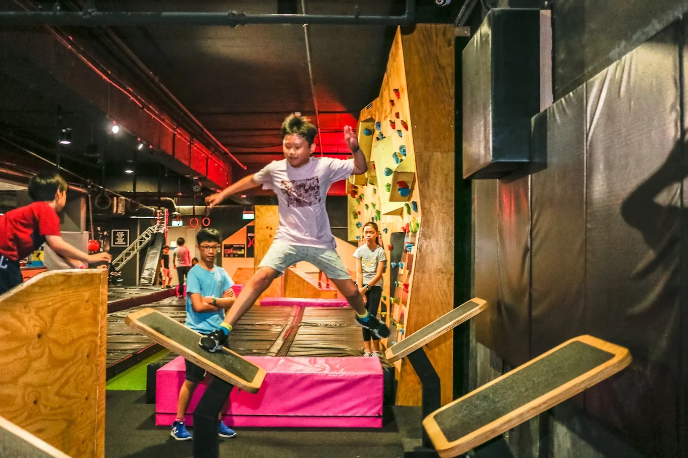 Student jumping across obstacle course at BOUNCE