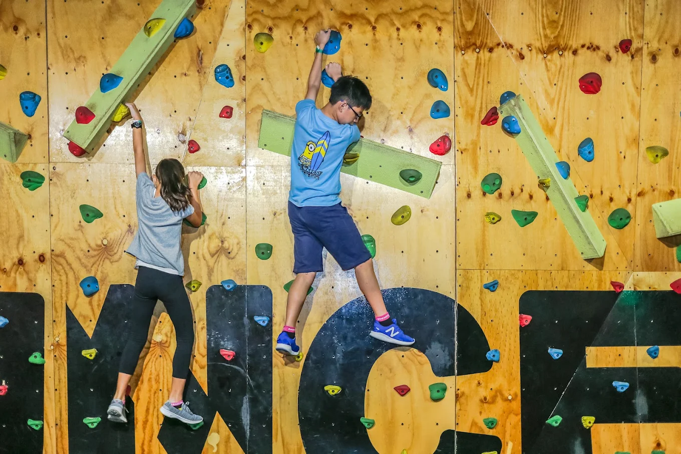 Two students climbing the BOUNCE wall